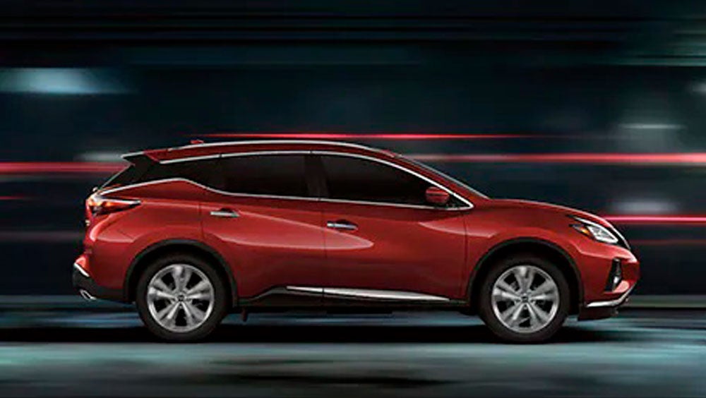 2023 Nissan Murano shown in profile driving down a street at night illustrating performance. | Nissan of Brandon in Tampa FL